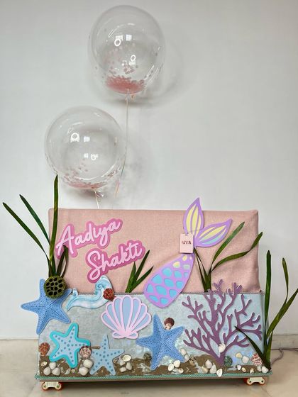 The complete mermaid-themed hamper, featuring a personalized name, confetti balloons, and an aquatic wonderland design.