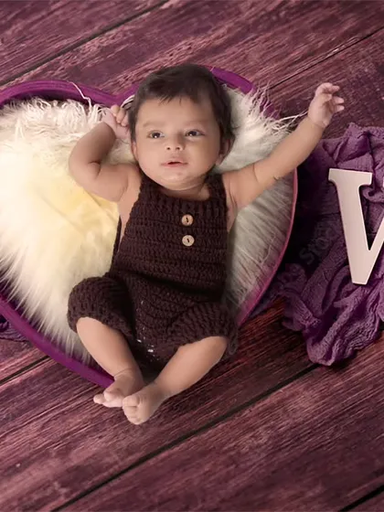 A lovely portrait of a two-month-old baby in a heart-shaped prop. I use simple wooden letters to add words like 'LOVE' to the setup.