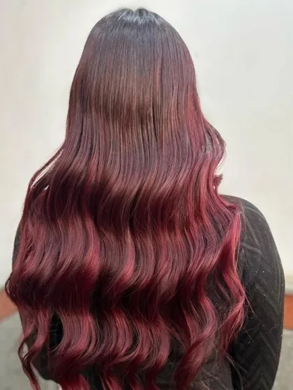 Another angle of the stunning red ombre, capturing how the light hits the waves and makes the color pop. This is a perfect style for making a statement.