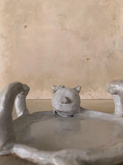 A whimsical cat-shaped dish, unglazed. The form is so playful and imaginative.