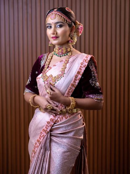 More shots of the bride in the pink and green kemp set, showing the intricate details of the choker, haaram, and the traditional headpiece.