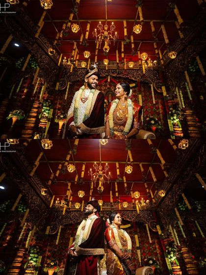 A majestic portrait of the couple under an ornate, beautifully lit ceiling, showcasing the grandeur of the venue.