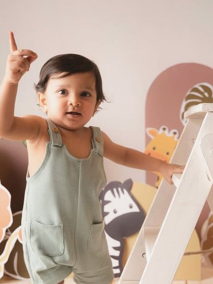 Pointing up to the sky, this little explorer is full of commands and cuteness during his safari birthday session.