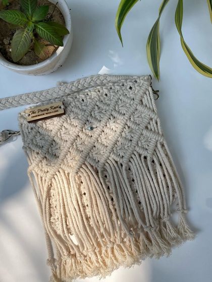 A simple and elegant macrame sling bag with fringe details. This design is versatile and can be made in 12 different colors to match your personal style.