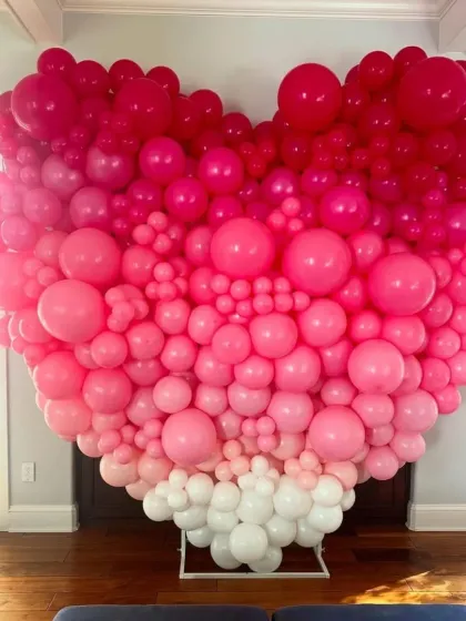 A huge heart-shaped balloon installation I created for a Valentine's celebration. The ombre effect from white to deep pink makes it a stunning photo backdrop.