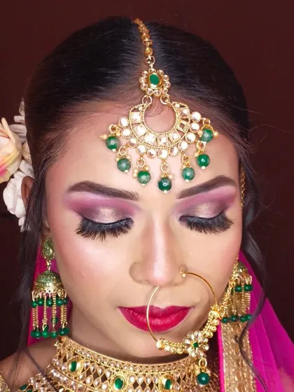 A close-up of a beautiful bridal eye makeup look. I used shades of pink and gold, with a sharp winged liner and full lashes.