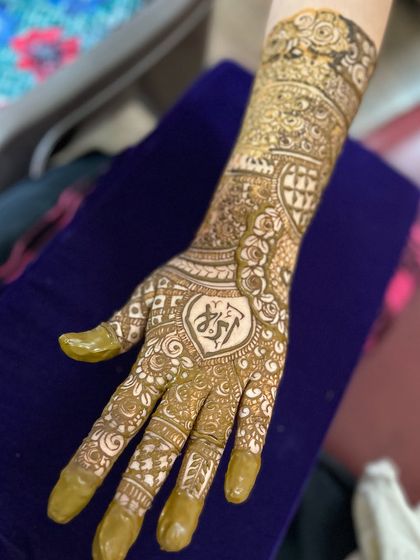 A non-bridal Indian design with a personalized heart and initial motif hidden in the palm.