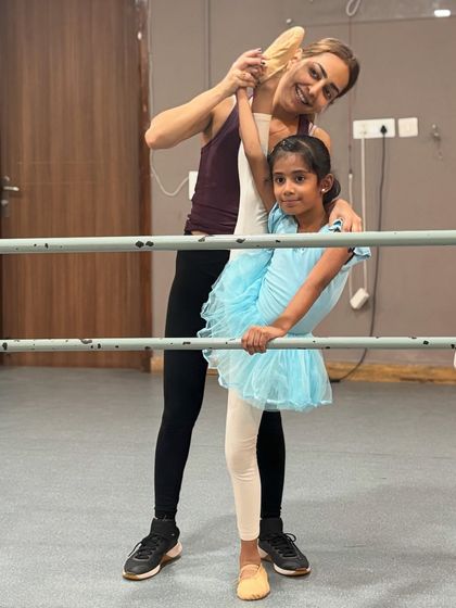 The foundation of ballet is built with patience and personal attention. Here, I am working closely with my students on their flexibility and alignment, key elements for their growth as dancers.