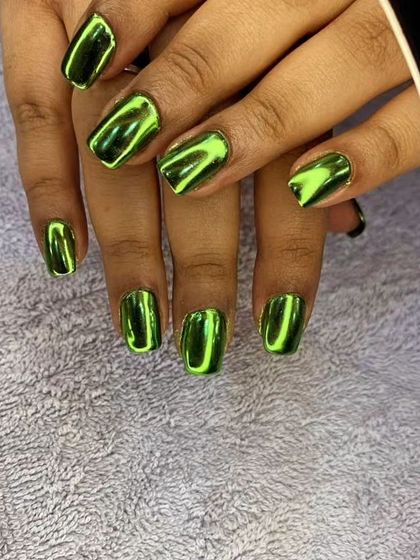Another view of the stunning green chrome nails, showcasing their mirror-like shine.