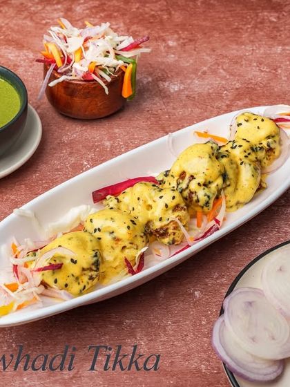 The Awhadi Tikka is known for its royal flavours. Marinated in a special blend of spices and yogurt, these chicken tikkas are creamy, tender, and subtly spiced.