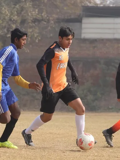 A snapshot from the Gurgaon Winter Cup, showing our U15 player skillfully maneuvering past a defender.
