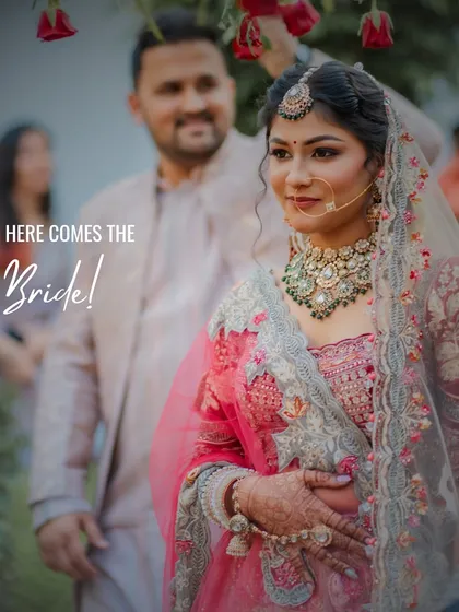 The bride's grand entrance, a moment filled with emotion and anticipation. I focus on capturing the genuine expressions and the beauty of the bridal lehenga and jewelry as she walks towards her new beginning.