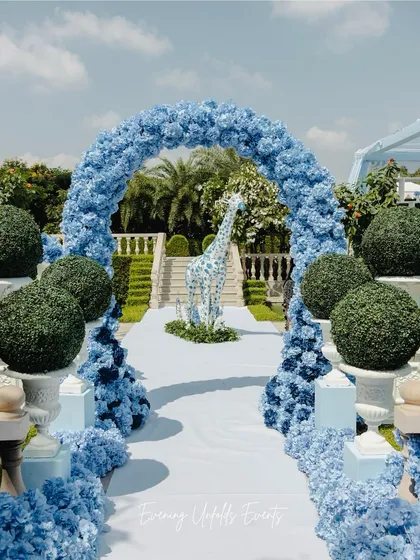 For a Dior-inspired Mehendi, we blended classic elegance with a touch of whimsy. This grand floral arch, made entirely of blue hydrangeas, frames a custom floral giraffe, showcasing our ability to execute high-concept, playful, and luxurious designs.