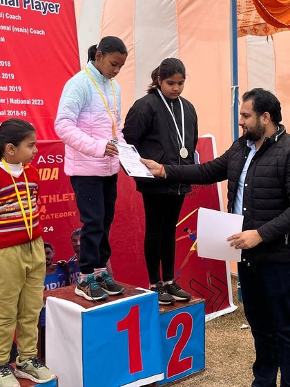 Celebrating a victory at a local meet. Even the youngest athletes learn the taste of victory through hard work.