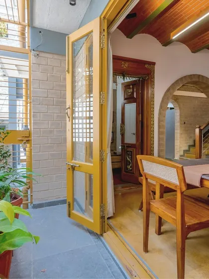 The dining area opening up to a green sit-out.