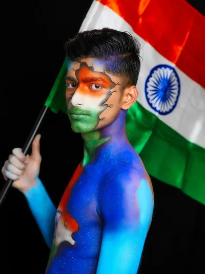 A proud and strong pose with the Indian flag, showcasing the student's detailed body painting work.