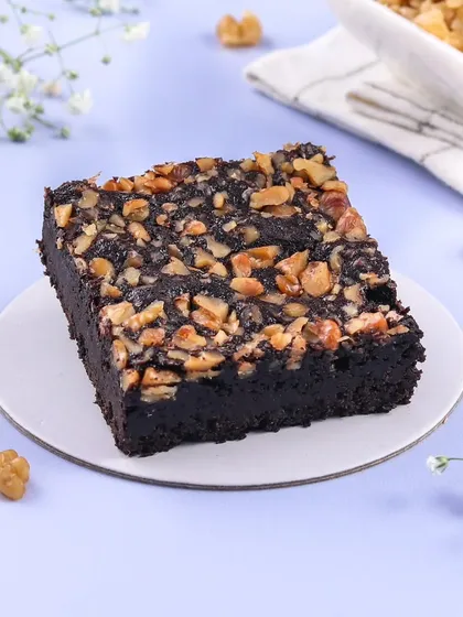 A classic Walnut Brownie, done right. My brownies are rich, fudgy, and made with dark chocolate, topped with a generous layer of crunchy walnuts for the perfect texture.