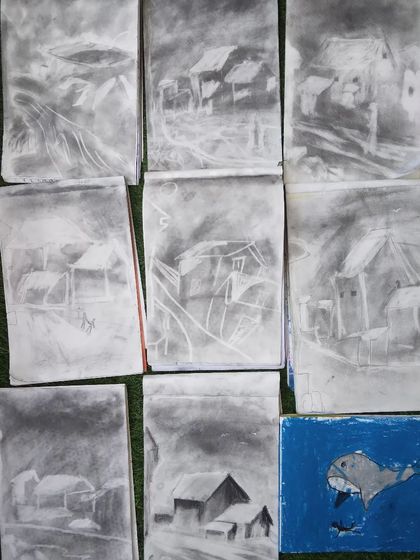 A collection of charcoal sketches where students learned to create atmospheric landscapes by removing charcoal with an eraser.