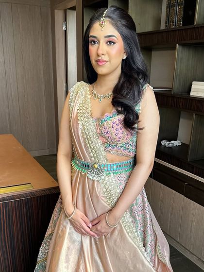The full look, showcasing the unique belted lehenga by Aditi Gupta. The makeup is soft and pretty, with pink tones that complement the pastel outfit perfectly.