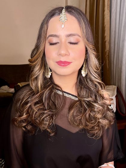 A close-up of the eye makeup, featuring soft, blended shadows and a defined lash line.