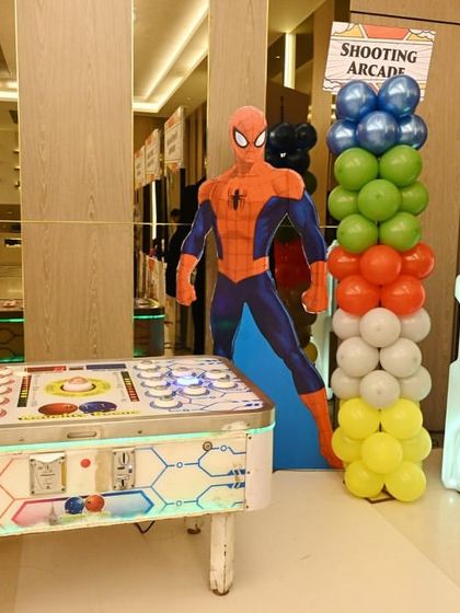 To complete the superhero headquarters feel, I brought in arcade-style games like this 'Naughty Bean' reaction table and a shooting arcade, all decorated to match the Spider-Man theme.