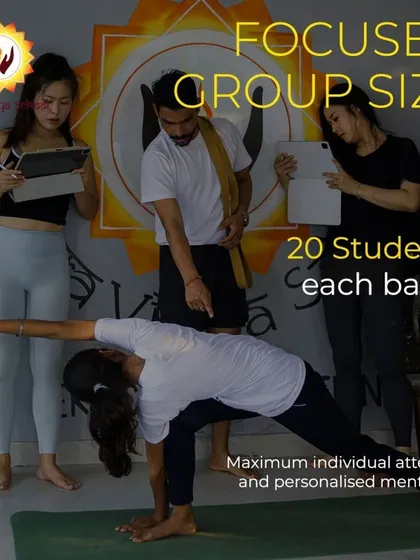 To ensure you receive true mentorship, I keep my teacher training groups small, with a maximum of 20 students per batch. This image shows a teacher providing personalized alignment correction, which is a core part of my programs. This focused attention is how you build the confidence to teach others.