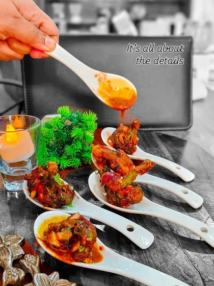It's all about the details. Here, we are adding the final drizzle of sauce to our Asian-flavored appetizers, ensuring each bite is perfectly balanced and beautifully finished.