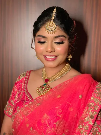 A close-up of Simran's eye makeup, featuring soft pink and champagne shimmers that make her eyes sparkle.