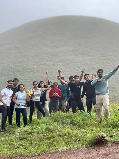 A fun group photo from the Kudremukha trek, with everyone celebrating the climb amidst the fog.