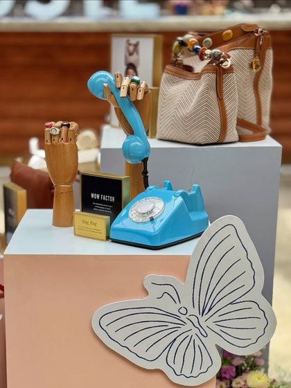We love incorporating quirky and thematic props into our designs. This display for Fossil featured a vintage-style telephone and wooden mannequin hands to creatively showcase the brand's bags and accessories.