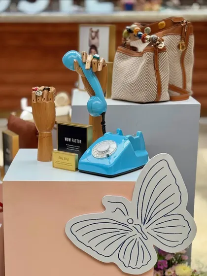 We love incorporating quirky and thematic props into our designs. This display for Fossil featured a vintage-style telephone and wooden mannequin hands to creatively showcase the brand's bags and accessories.