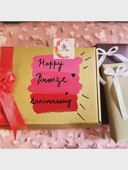 A personalized "Happy Bronze Anniversary" gift box, hand-painted with shades of pink and red. This shows how I can create unique, themed gifts to celebrate special relationship milestones like an 8th anniversary.