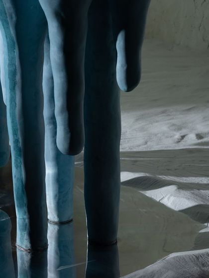 The reflection in the water emphasizes the icicle-inspired form of our concrete console. This shot captures the essence of our Nature's Alchemy collection, where we transform natural phenomena into tangible, lasting designs for your home.