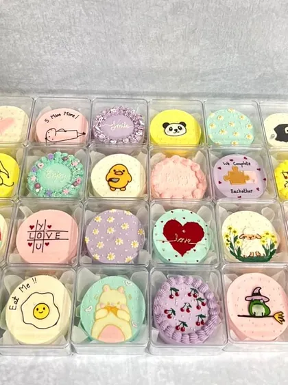My mini bento cakes are where I get to have so much fun with cute, hand-drawn designs. Each one is a tiny piece of art, perfect for gifting or just treating yourself. I love seeing all the different characters and patterns come to life in a single collection.