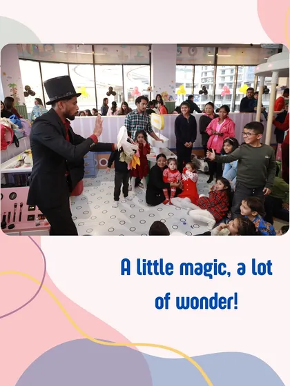 A little magic, a lot of wonder. A magician entertains a captivated audience of children during a birthday party.