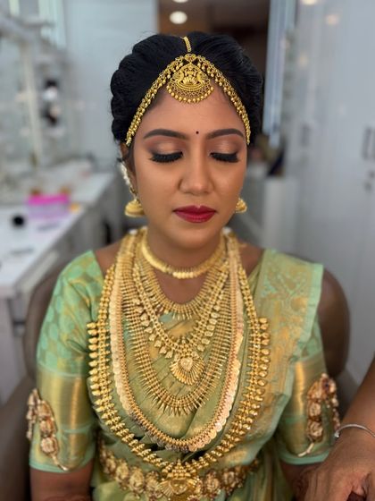 A close-up of Harina's makeup with her eyes closed, showing the blended eyeshadow and sharp winged liner. This is my signature traditional eye makeup style.