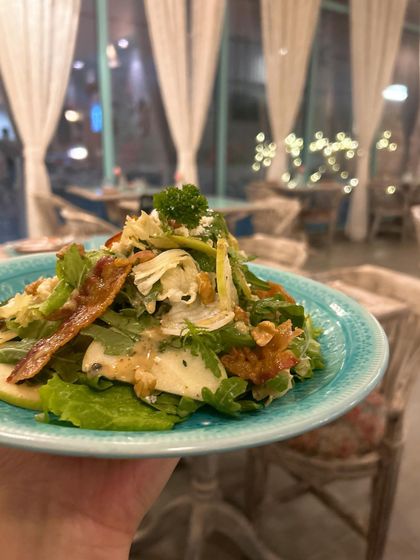 A fresh and crisp salad from Rose Cafe. Holding the plate up allows me to capture the dish with the beautiful, blurry background of the cafe's interior.