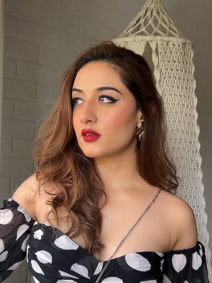 The retro glam look on Uditi Singh. A sharp cat-eye and vibrant red lipstick create a look that is both vintage and modern, perfect for a themed shoot or a party.