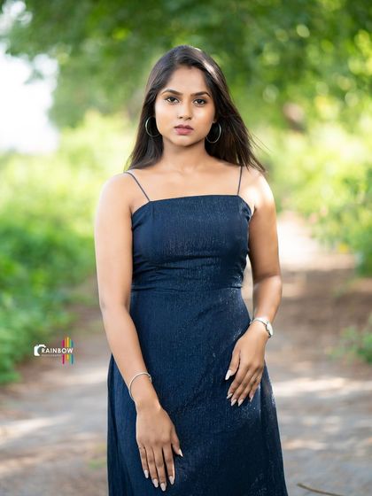 A full-length shot that captures a classic model pose against a natural background.