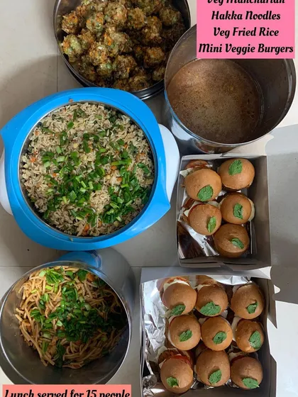 An Indo-Chinese lunch served for 15 people, including Veg Manchurian, Hakka Noodles, and Veg Fried Rice.