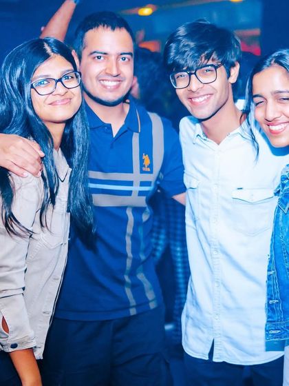 A group of friends posing for a photo, happy to be at the event.