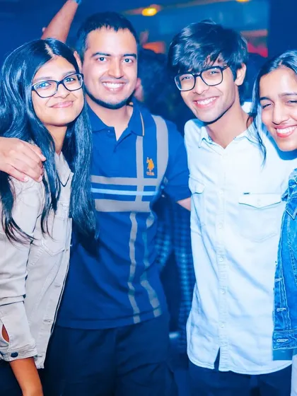 A group of friends posing for a photo, happy to be at the event.