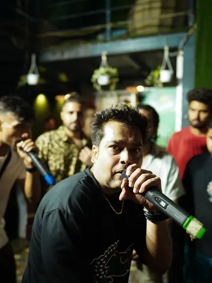 An artist commanding the microphone during the rap battle segment. These cyphers are a great opportunity for performers to test their skills and gain stage experience.
