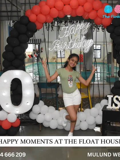 The birthday girl posing proudly in front of her custom party setup. We love creating these happy moments.
