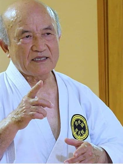 Grand Master Zenpo Shimabukuro, 10th Dan Red Belt, explaining a principle of karate. He is the son of our founder, Zenryo Shimabukuro, and continues his father's legacy.