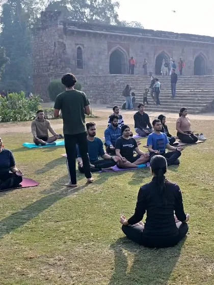 Leading a community yoga session. As Mahatma Gandhi said, our habits become our values, and our values become our destiny. Let's build positive habits together.
