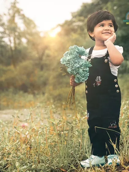 A dreamy outdoor portrait of a little girl enjoying nature. The golden hour sunlight adds a magical touch to this pre-birthday shoot.