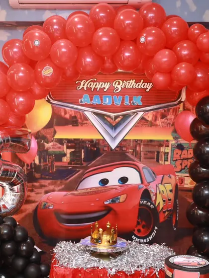Ready, set, celebrate! For this party, I brought the world of Disney's Cars to life with a custom-themed cake table, complete with a Radiator Springs backdrop and a red balloon arch. It’s the perfect setup for any little racing fan.
