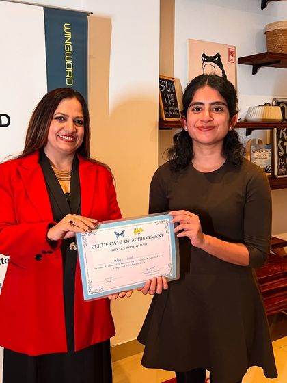 A poet receives her certificate, marking her achievement in the Wingword competition.