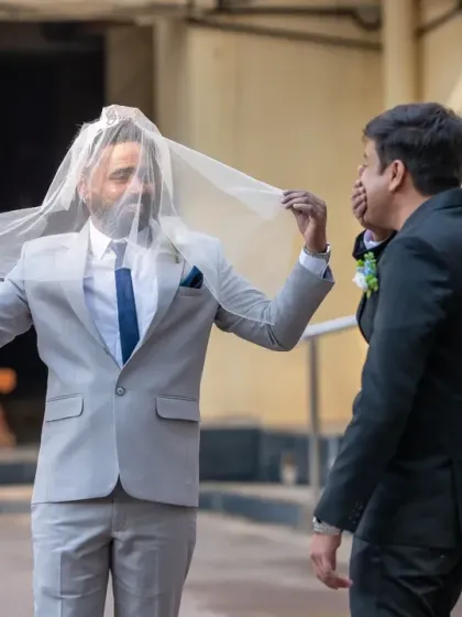 You've got to have some laughs on your wedding day! This candid shot of the groomsmen sharing a lighthearted moment with the bride's veil is exactly the kind of fun, unscripted memory I love to capture.